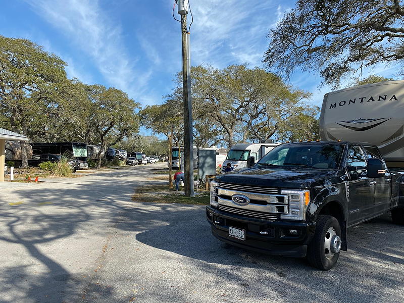 The Augustine Beach KOA campground has an A-frame style main office to greet you, and many trees.