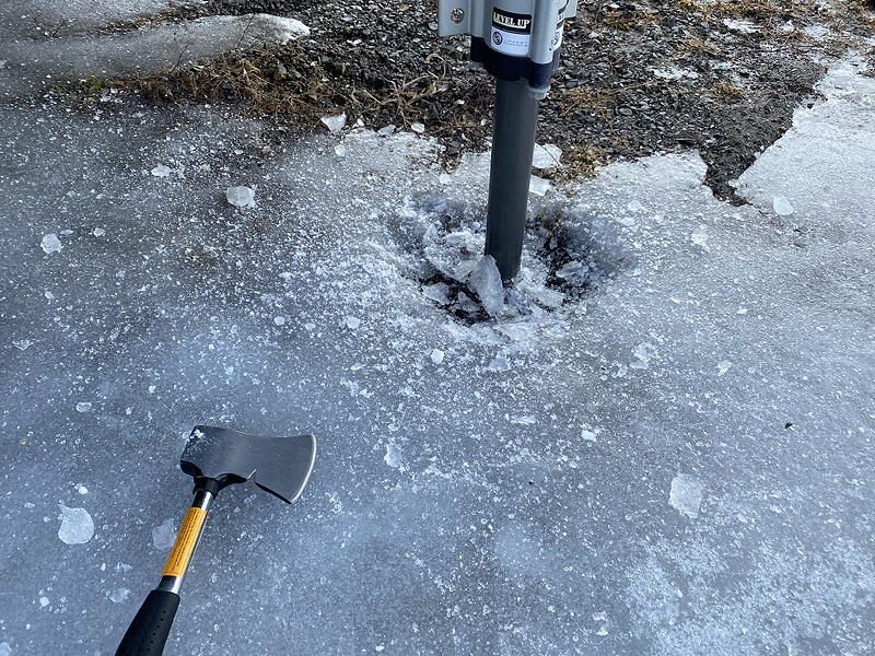 The overnight freeze has encased our trailer's landing gear in ice, but a hatchet makes short work of that.