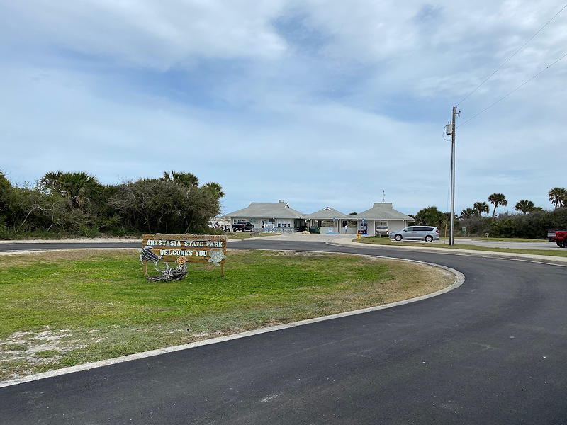 After entering the Anastasia State Park vehicle entrance, you travel down this short road past all the parking lots to arrive at the main building housing restroom facilities, a hot food area, and a souvenir store.