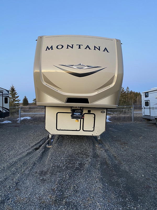 This head on view of our trailer at the storage yard shows the lean resulting from the tires on the left having sunken into the gravelly mud.